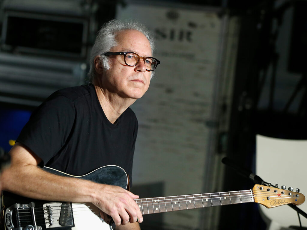 Bill Frisell holding one of his many guitars