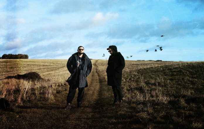 The Twilight Sad standing in a grim looking field
